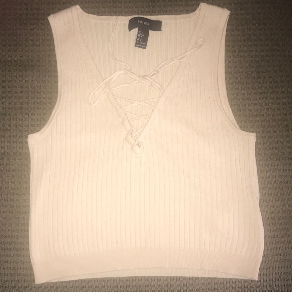 cream colored crop top with cross cross detailing.